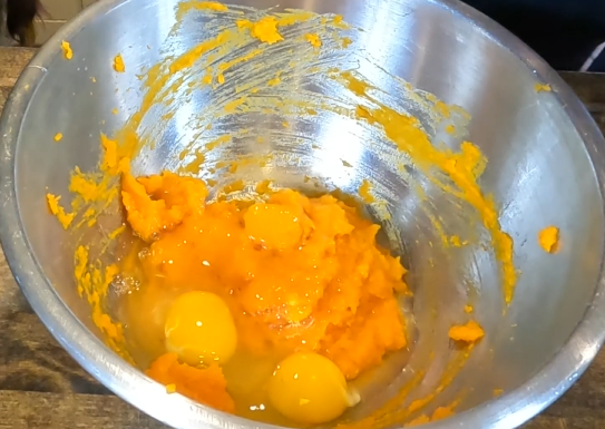 puree with three eggs in a stainless steel bowl