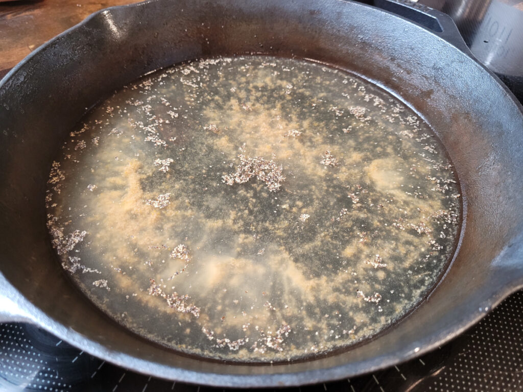 broth with salt and pepper added in cast iron skillet