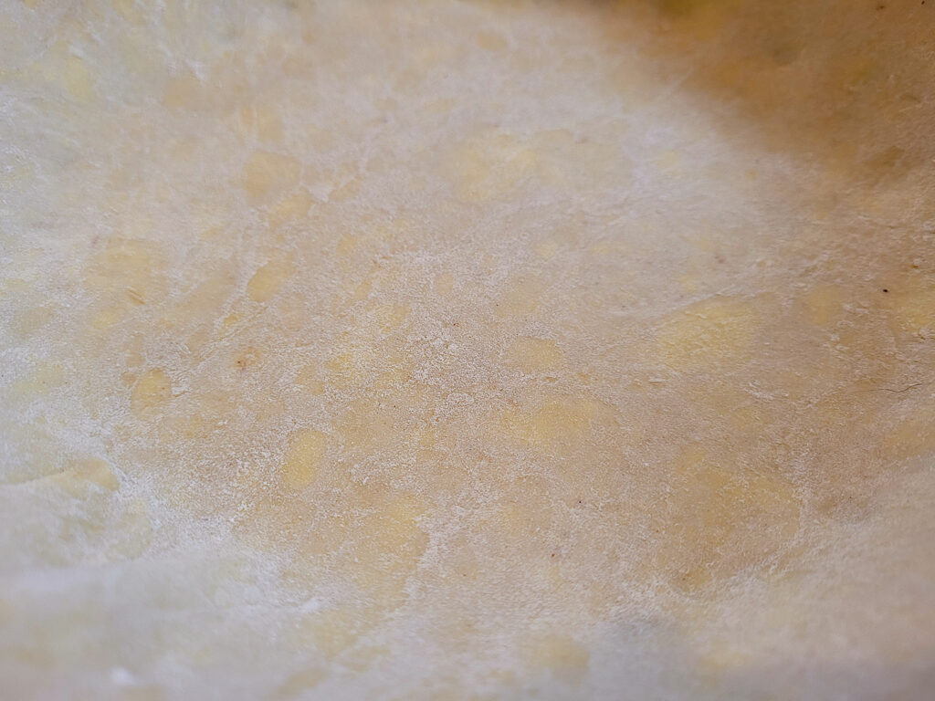 Close up of pie crust with buttery flakes