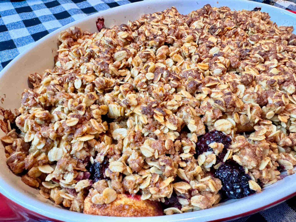 baked apple and blackberry crisp in a casserole dish