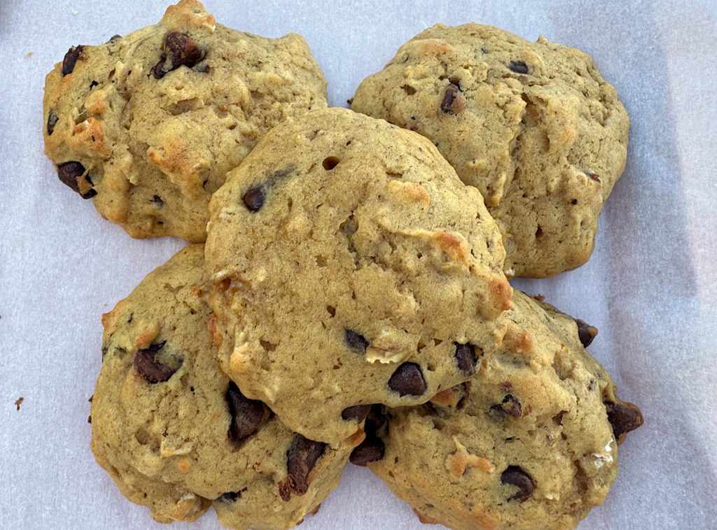 5 acorn squash chocolate chip cookies stacked on parchment paper