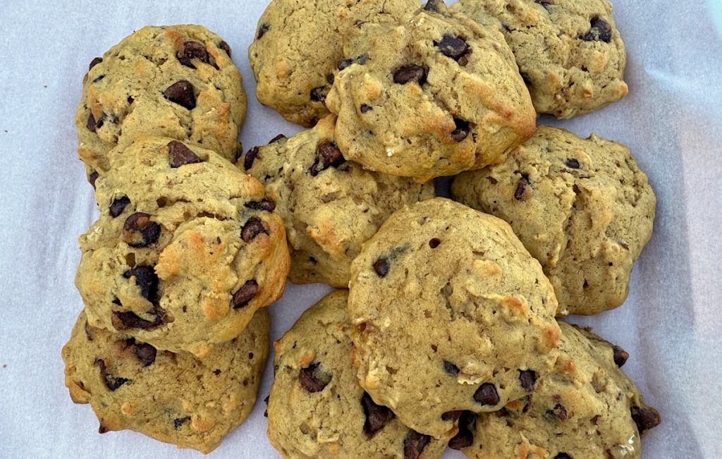 11 acorn squash chocolate chip cookies stacked on parchment paper