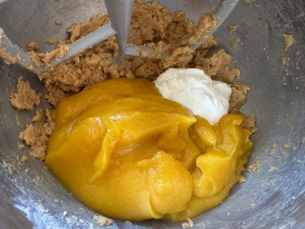 2 cups acorn squash puree and 1/2 cup yogurt added to creamed butter and sugar in a stainless steel mixing bowl
