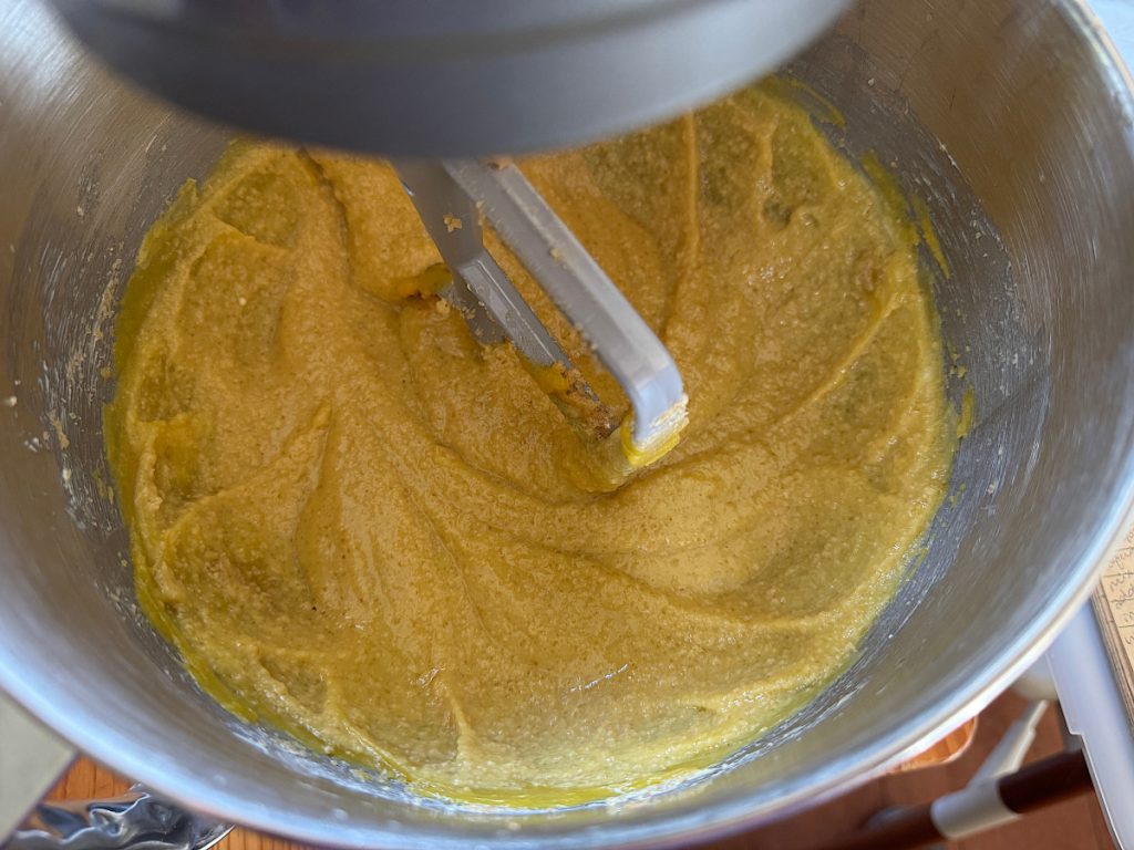 acorn squash batter without the dry ingredients in a stainless steel mixing bowl