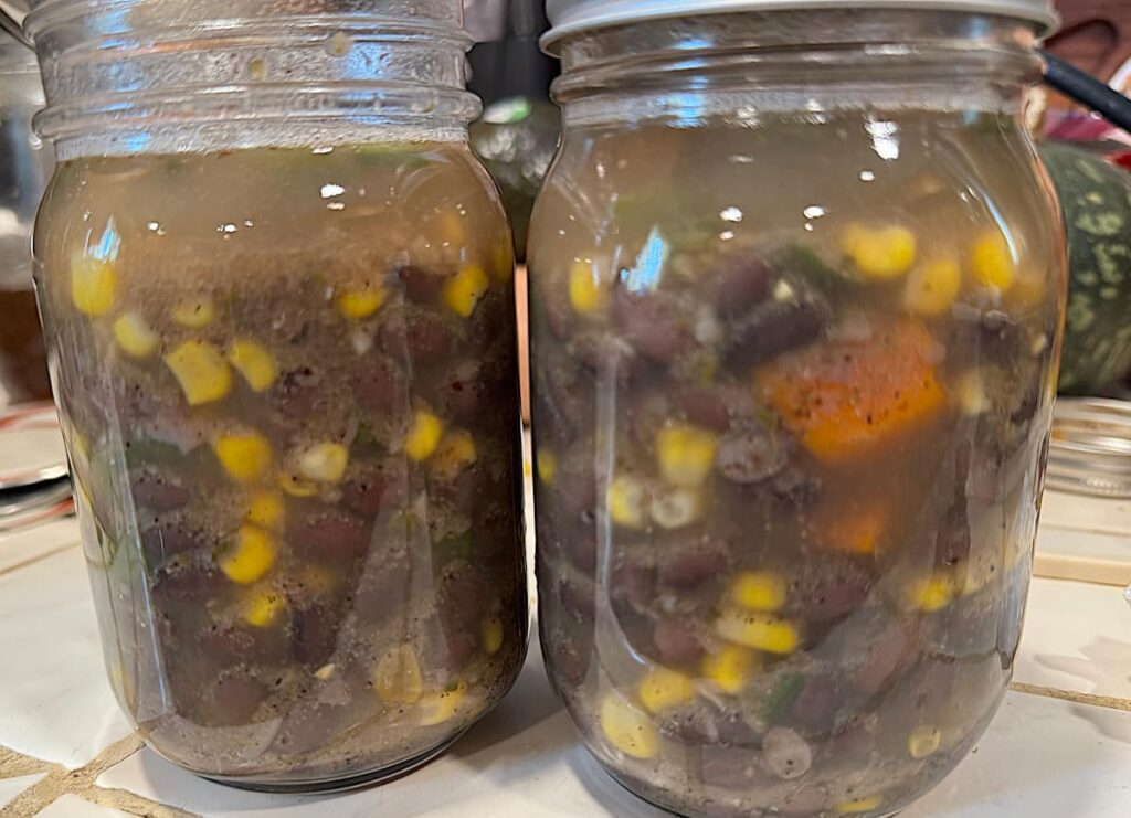 2 pint jars filled with black bean soup