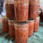 jars of seasoned black beans on a green towel lined table