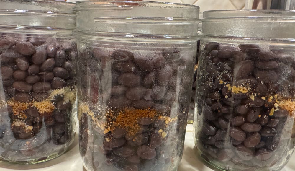 3 jars full of black beans and seasonings with no water