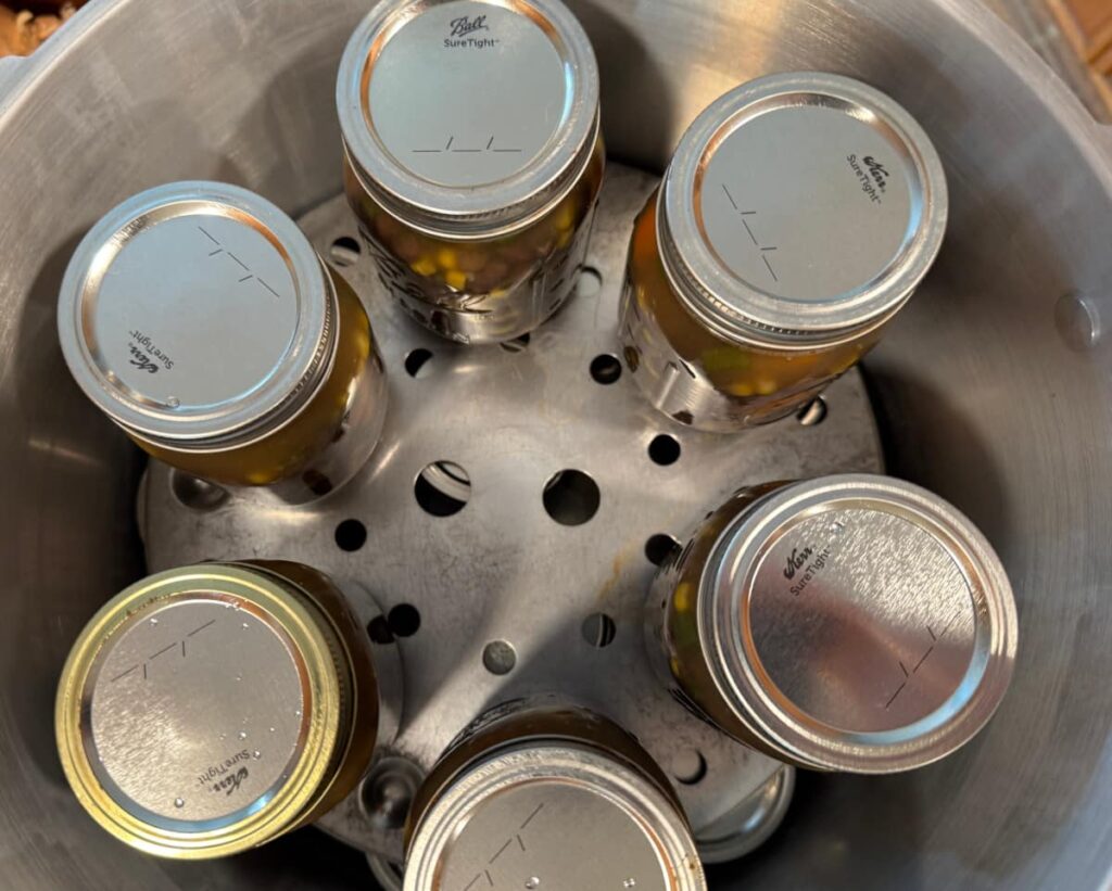 top down view of 6 pint jars of black bean soup in Presto 23 quart canner