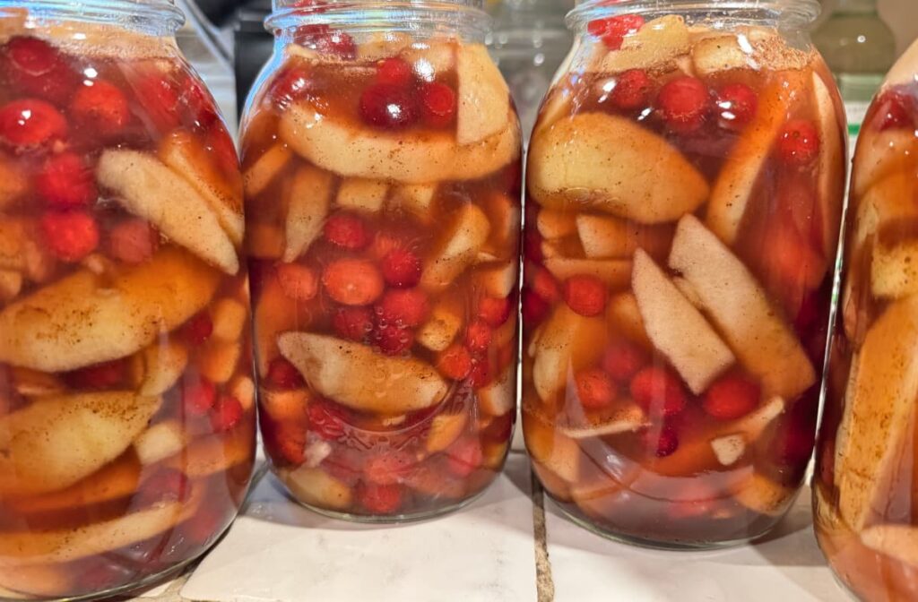 Jars filled with Apple Cranberry Pie Filling before canning