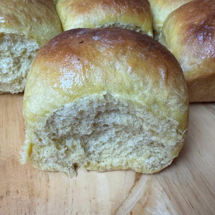 butternut squash dinner roll on a wood surface