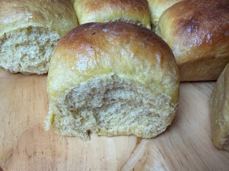 butternut squash dinner roll on a wood surface