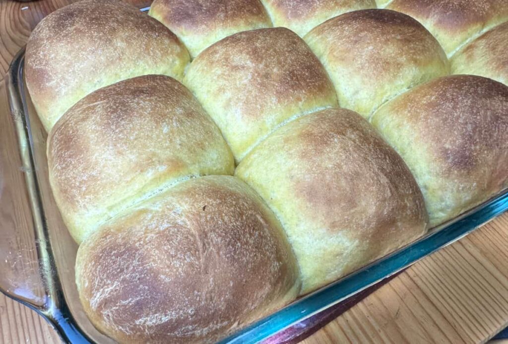 butternut squash dinner rolls on a wooden table