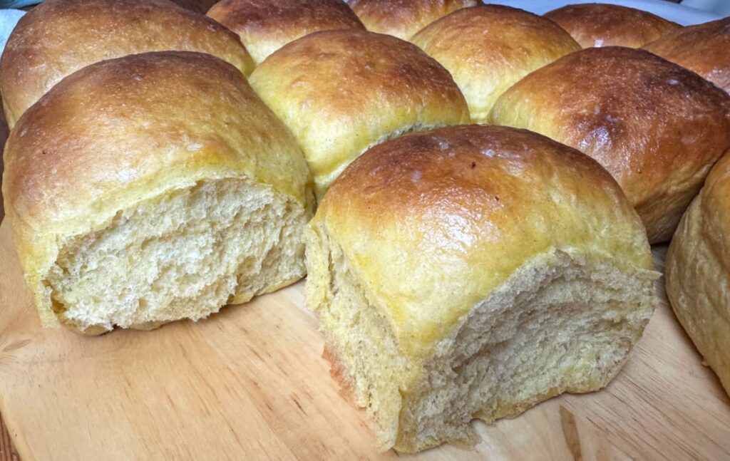 butternut squash dinner rolls on a wooden table