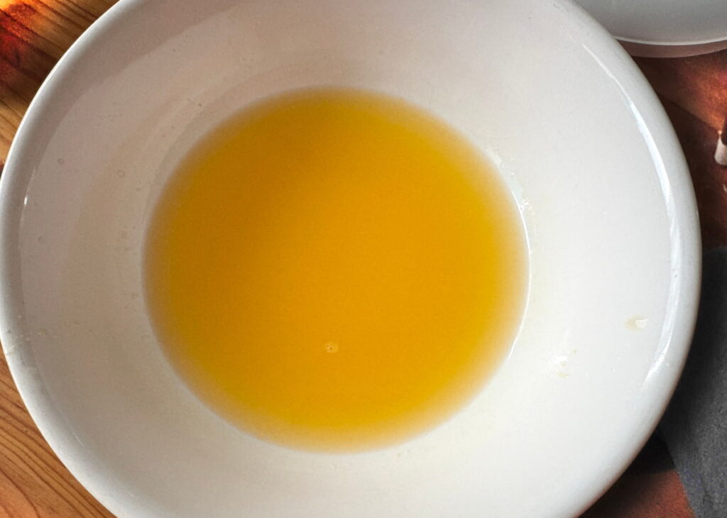 fresh squeezed orange juice in a white bowl