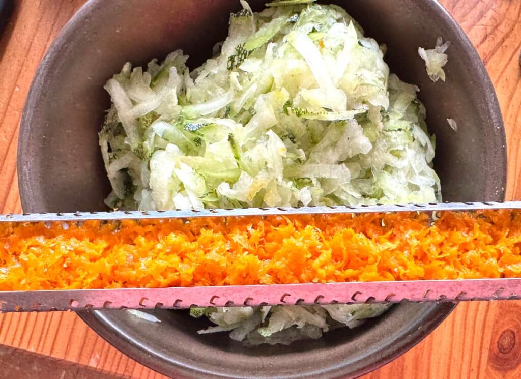 bowl of shredded zucchini with the zest of one orange